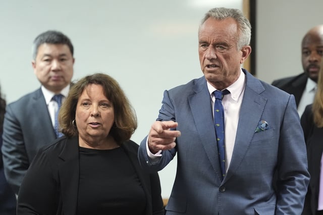 U.S. Health Secretary Robert F. Kennedy Jr., right, is accompanied by Susan Levy, Native Health Communications and Community Relations director, during a tour of the Native Health Mesa Food Distribution Center, in Mesa, Ariz., Tuesday, April 8, 2025. (AP Photo/Ross D. Franklin)