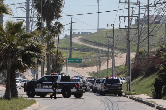 Members of security forces work near a crime scene where a U.S. citizen shot and killed Abigail Esparza Reyes, 33, a top Mexican state police officer in an elite unit known as the "Gringo Hunters", which tracks and arrests U.S. fugitives in Mexico, in Tijuana, Mexico, April 9, 2025. REUTERS/Stringer