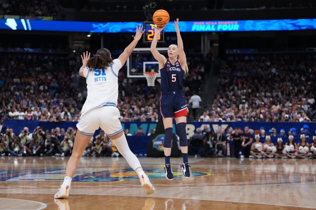 UConn Huskies guard Paige Bueckers (5) shoots against UCLA Bruins center Lauren Betts (51) during the women's 2025 NCAA tournament.