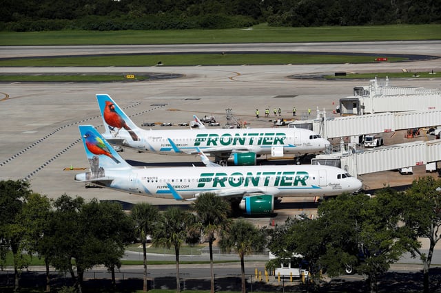 Frontier airlines planes are parked at the boarding gates at Tampa International Airport in Tampa, Florida, U.S., July 19, 2024. REUTERS/Octavio Jones/File Photo