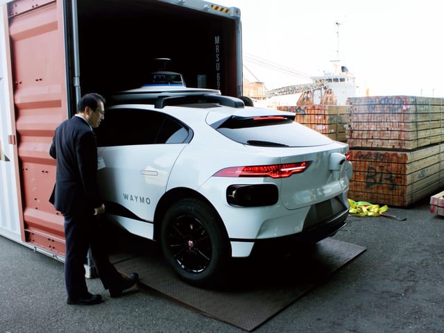A Waymo comes out of a shipping container at an undisclosed port in Japan.