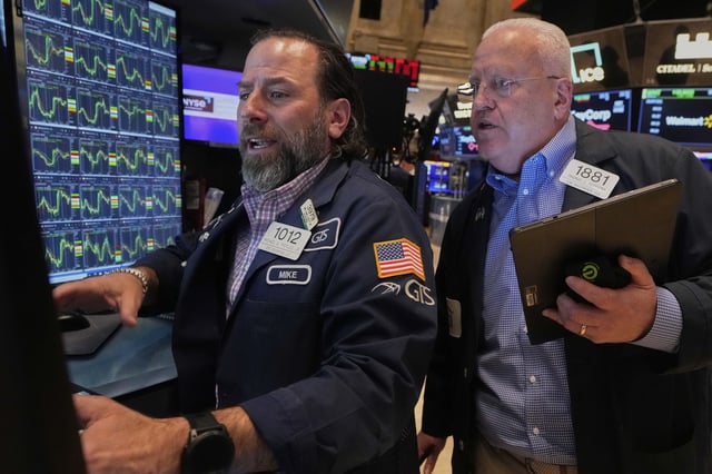 Specialist Michael Pistillo, left, and trader Thomas Ferrigno work on the floor of the New York Stock Exchange, Thursday, April 10, 2025. (AP Photo/Richard Drew)