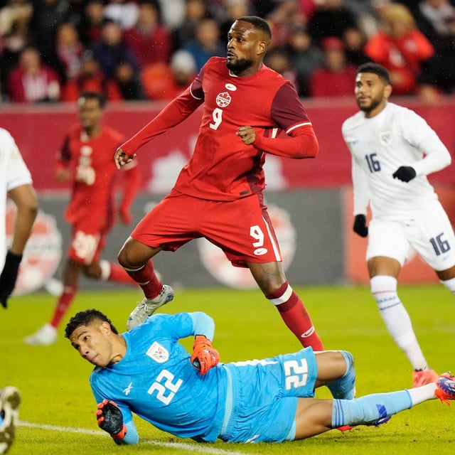 Canada's Cyle Larin (9) watches the ball sail into the net as he scores on Panama goalkeeper Orlando Mosquera (22) during first half men's international friendly soccer action in Toronto, on Tuesday, October 15, 2024. THE CANADIAN PRESS/Frank Gunn