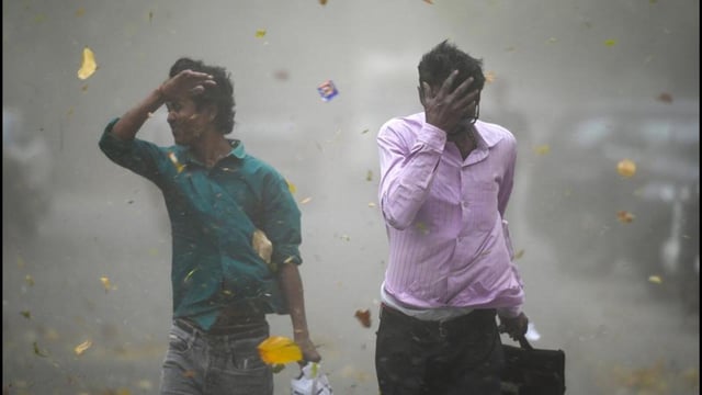 The sudden dust storm late Thursday affected parts of Noida and Greater Noida, disrupting traffic and forcing pedestrians to take cover. (Sunil Ghosh/HT Photo)