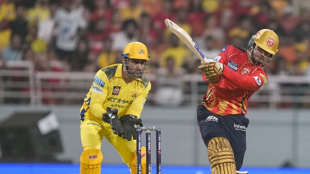 MS Dhoni (L) looks on as Priyansh Arya deposits one into the stands