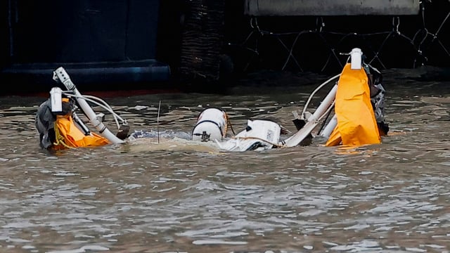 An object floats at the scene of a helicopter crash on the Hudson River near lower Manhattan in New York, as seen from Newport, New Jersey, U.S., April 10, 2025. REUTERS/Eduardo Munoz