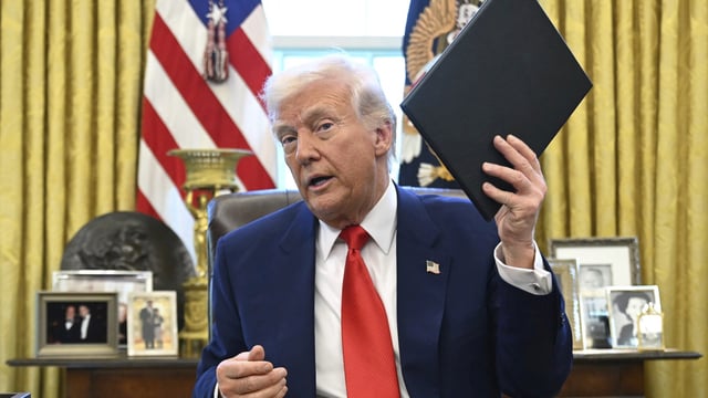 President Donald Trump holds an executive order in the Oval Office of the White House Wednesday, April 9, 2025, in Washington. AP/PTI(AP04_10_2025_000017B)