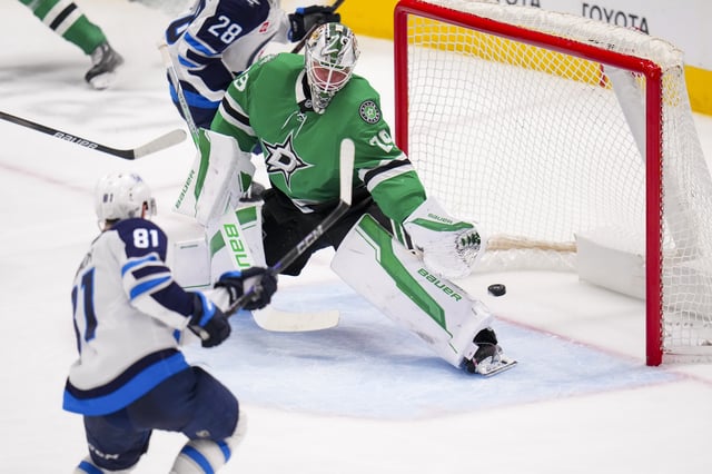 Winnipeg Jets left wing Kyle Connor (81) scores a goal on Dallas Stars goaltender Jake Oettinger (29) during the third period of an NHL hockey game Thursday, April 10, 2025, in Dallas. (AP Photo/Julio Cortez)