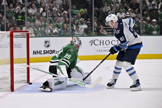 Apr 10, 2025; Dallas, Texas, USA; Winnipeg Jets left wing Kyle Connor (81) scores a goal against Dallas Stars goaltender Jake Oettinger (29) during the third period at the American Airlines Center. Mandatory Credit: Jerome Miron-Imagn Images