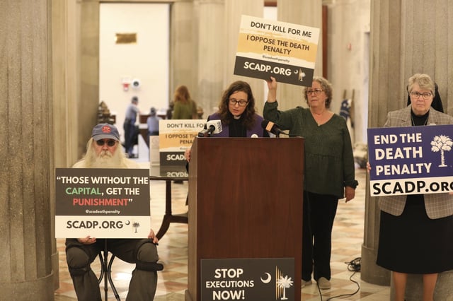 Members of South Carolinians for Alternatives to the Death Penalty speak before presenting petitions to South Carolina Gov. Henry McMaster asking him to grant clemency to Mikal Mahdi before his firing squad execution during a news conference on Thursday, April 10, 2025, in Columbia, S.C. (AP Photo/Jeffrey Collins)
