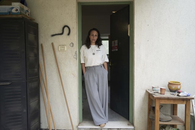 Lishay Miran Lavi, whose husband of Omri Miran is held captive by Hamas in the Gaza Strip, poses for a portrait at the family's home in Kibbutz Nahal Oz, southern Israel, Wednesday, April 9, 2025. (AP Photo/Maya Alleruzzo)