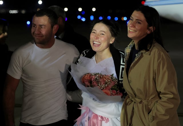 Ksenia Karelina, a Russian-American dual citizen who was released from detention in Russia, reacts as she arrives at Joint Base Andrews in Maryland, U.S., April 10, 2025. REUTERS/Kevin Mohatt