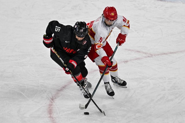 Japan&#39;s Rui Ukita fights for the puck with China&#34;s Du Sijia (R) in the women&#39;s ice hockey match during the Harbin 2025 Asian Winter Games in Harbin, Northeast China&#39;s Heilongjian province on February 14, 2025.