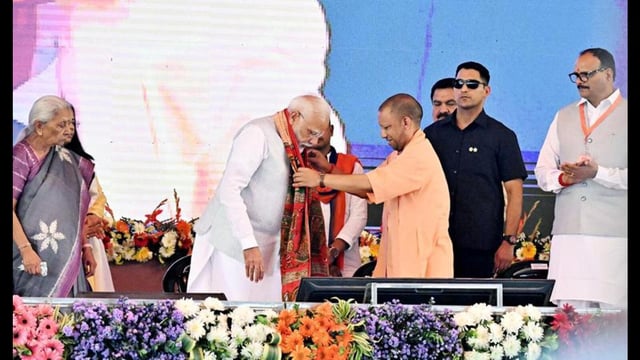 Prime Minister Narendra Modi being felicitated by chief minister Yogi Adityanath, as he reaches the venue in his parliamentary constituency, in Varanasi on Friday. UP governor Anandiben Patel and deputy chief minister Brajesh Pathak also seen. (ANI Photo)