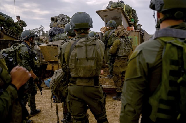 SOUTHERN ISRAEL - DECEMBER 14: Reservists prepare their belongings before entering Gaza at a staging point near the Gaza border on December 14, 2023 in Southern Israel. It has been more than two months since the Oct. 7 attacks by Hamas that prompted Israel's retaliatory air and ground campaign in the Gaza Strip. (Photo by Alexi J. Rosenfeld/Getty Images)