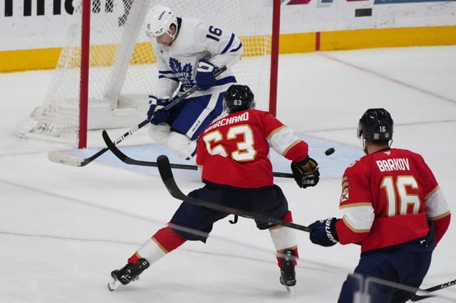 Toronto Maple Leafs right wing Mitch Marner (16) defends a shot on the goal by Florida Panthers center Brad Marchand (63) during the third period of an NHL hockey game, Tuesday, April 8, 2025, in Sunrise, Fla. (AP Photo/Lynne Sladky)