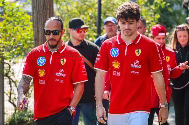 Lewis Hamilton of Great Britain and Ferrari and Charles Leclerc of Monaco and Ferrari walk in the paddock during practice/Sprint qualifying ahead of the F1 Grand Prix of China at Shanghai International Circuit on March 21, 2025 in Shanghai, China.