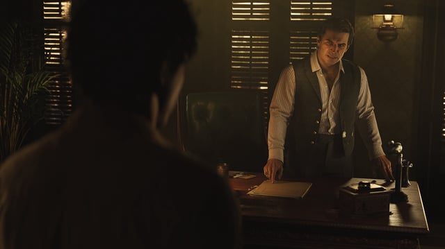 Two men standing in a darkened Sicilian office in Mafia: The Old Country.
