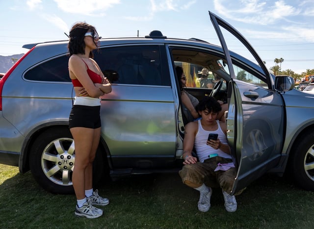 Marissa Prieto (left) Juan Guardado (right) and Alle Suviate (in back) all of Orange County, California, wait to get into the car camping area at Coachella on Thursday, April 10, 2025.