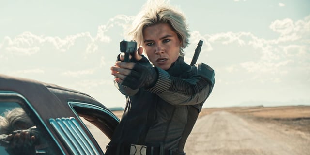 Florence Pugh hanging out a car window aiming her pistol as Yelena in Thunderbolts*.