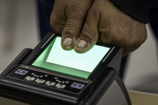 A Peruvian citizen has his thumb prints taken while renewing official documents at a Peruvian consulate mobile outreach event on March 29, 2025 at an undisclosed location, Connecticut.