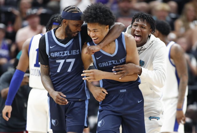 Jaylen Wells #0 of the Memphis Grizzlies is hugged by DeJon Jarreau #77 after scoring the game-winning basket at the buzzer during their NBA Summer League game against the Philadelphia 76ers. Jaylen Wells has now been ruled out for the rest of the season.