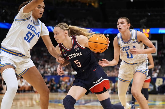UConn guard Paige Bueckers (5) drives against UCLA center Lauren Betts (51) and guard Gabriela Jaquez (11) during the first half of a national semifinal Final Four game during the women&#39;s NCAA college basketball tournament, Friday, April 4, 2025, in Tampa, Fla. 
