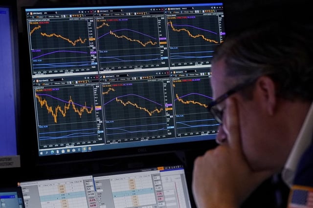 Specialist Gregg Maloney works at his post on the floor of the New York Stock Exchange, Thursday, April 10, 2025, in New York. (AP Photo/Richard Drew)