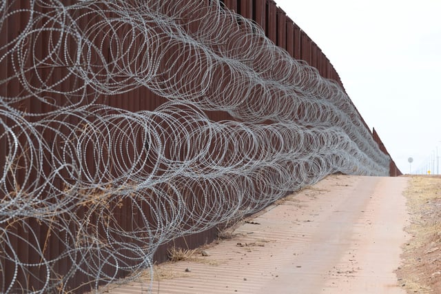 Concertina wire is attached along the fence at the southern US border with Mexico, in Douglas, Arizona, on April 3.