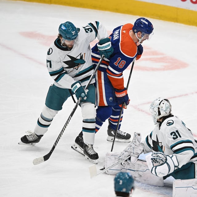 Apr 11, 2025; Edmonton, Alberta, CAN; San Jose Sharks defenceman Timothy Lijegren (37) get in front of Sharks goalie Georgi Romanov (31) as Edmonton Oilers left winger Zach Hyman (18) looks on during the first period at Rogers Place. Mandatory Credit: Walter Tychnowicz-Imagn Images