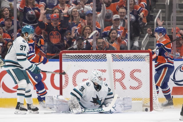 San Jose Sharks' goalie Georgi Romanov (31) is scored on by Edmonton Oilers' Ty Emberson (49) as Connor McDavid (97) and Timothy Liljegren (37) look on during first period NHL action in Edmonton on Friday, April 11, 2025.