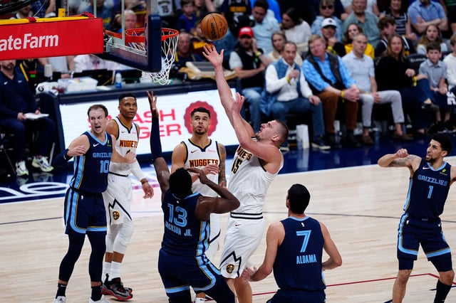 Jokić shoots the ball over Memphis Grizzlies forward Jaren Jackson Jr. during the game.