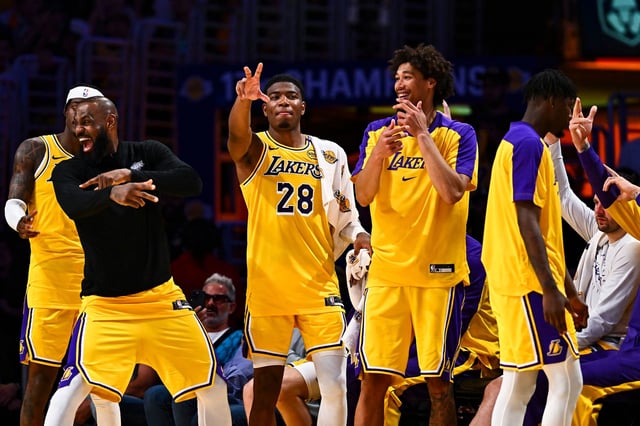 LeBron James celebrates with his teammates after the Lakers scored against the Houston Rockets.