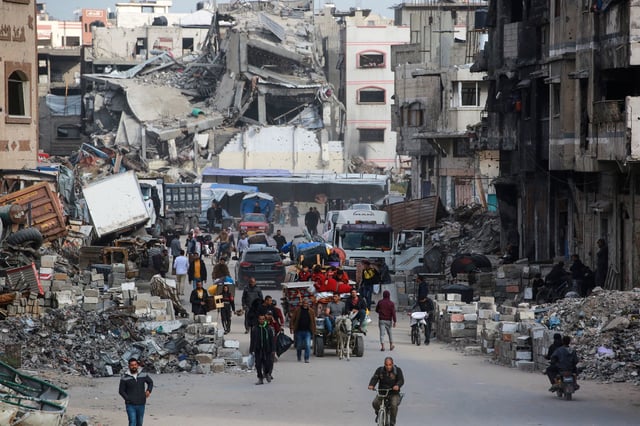 Palestinians ferry their belongings as they arrive in Gaza City to flee neighbourhoods to the east of the city following Israeli evacuation orders on April 11, 2025.