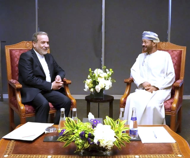 In this photo released by the Iranian Foreign Ministry, Iranian Foreign Minister Abbas Araghchi, left, meets his Omani counterpart Sayyid Badr Albusaidi prior to negotiations with U.S. Mideast envoy Steve Witkoff in Muscat, Oman, Saturday, April 12, 2025. (Iranian Foreign Ministry via AP)
