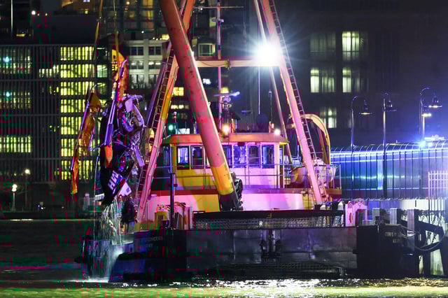 A crashed helicopter is raised from the Hudson River on April 10, 2025, in Jersey City.