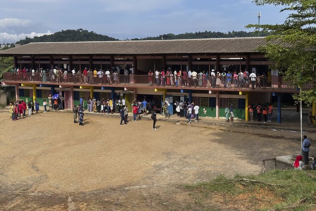 Voters queue to cast their votes for the presidential elections outside a polling station, in Liberville, Gabon, Saturday, April 12, 2025. (AP Photo/Betines Makosso)
