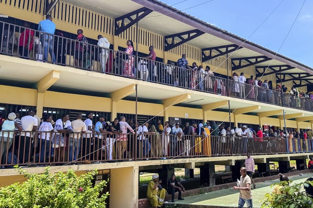 Voters queue up outside a polling station to cast their votes for the presidential elections in Liberville, Gabon, Saturday, April 12, 2025. (AP Photo/Betines Makosso)