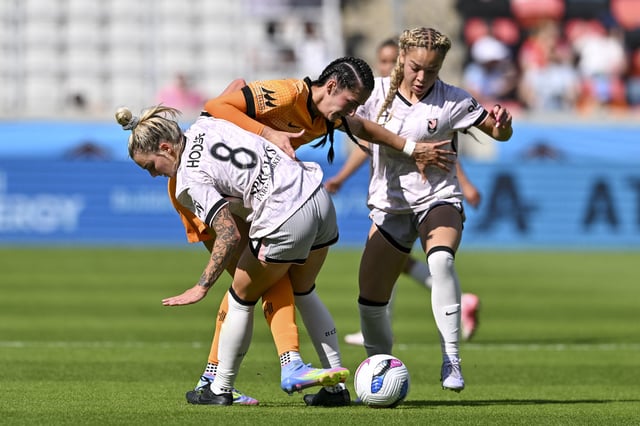Apr 12, 2025; Houston, Texas, USA; Houston Dash forward Diana Ordonez (9) battle for control of the ball as Angel City FC midfielder Macey Hodge (8) and defender Savy King (3) defend during the first half at Shell Energy Stadium. Mandatory Credit: Maria Lysaker-Imagn Images