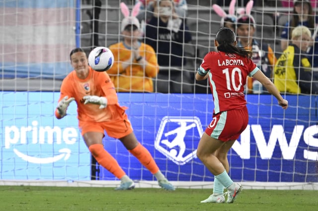Apr 12, 2025; San Diego, California, USA; Kansas City Current midfielder Lo'eau LaBonta (10) scores past San Diego Wave FC goalkeeper Kailen Sheridan (1) on a penalty kick during the first half at Snapdragon Stadium. Mandatory Credit: Denis Poroy-Imagn Images