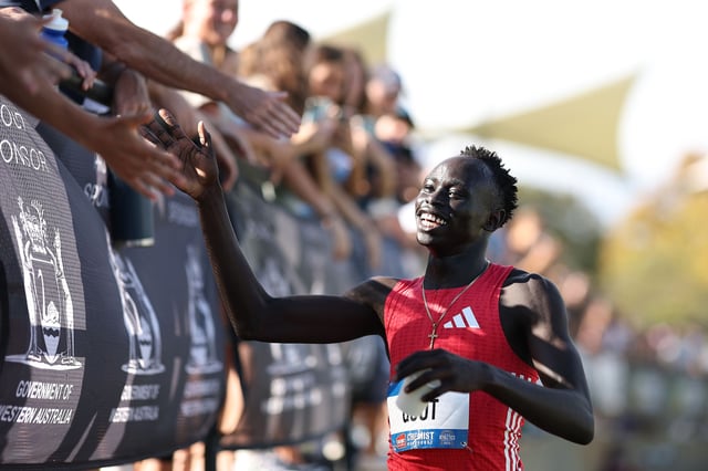 Gout Gout celebrates with spectators after winning the men's 200m at Australia's national championships.
