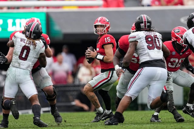 Georgia quarterback Carson Beck (15) looks for an open receiver against South Carolina on Sept. 16, 2023, in Athens, Georgia. Beck, now with Miami, is about to start throwing after having surgery on his elbow. (AP Photo/John Bazemore)