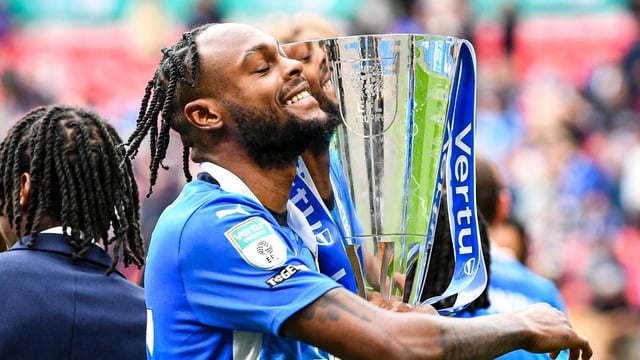 Jones shows off the EFL Trophy after Peterborough’s shock victory over the League One champions