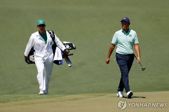 An Byeong-hun of South Korea (R) walks on the second green during the final round of the Masters at Augusta National Golf Club in Augusta, Georgia, on April 13, 2025, in this Getty Images photo. (Yonhap)