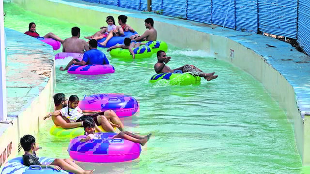 People cool off on a sunny afternoon at a water park in Noida’s GIP Mall. (Sunil Ghosh/HT Photo)