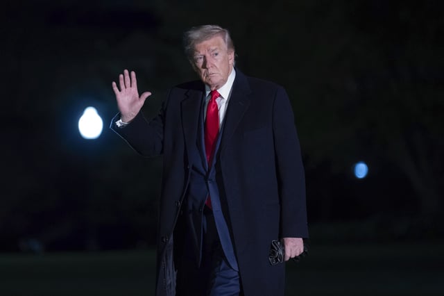 President Donald Trump gestures to reporters as he walks on the South Lawn of the White House in Washington, Sunday, April 13, 2025. (AP Photo/Jose Luis Magana)