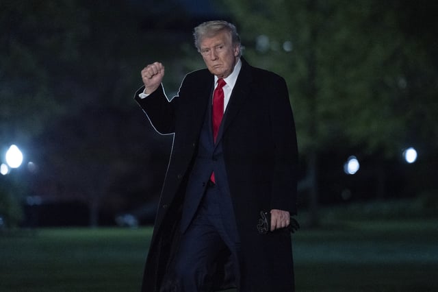 President Donald Trump gestures to reporters as he walks on the South Lawn of the White House in Washington, Sunday, April 13, 2025. (AP Photo/Jose Luis Magana)