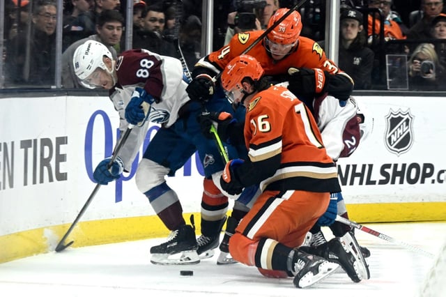 Colorado Avalanche center Martin Necas (88) vies for the puck with Ducks center Ryan Strome (16) and defenseman Pavel Mintyukov (34) during the second period of an NHL hockey game in Anaheim, Calif., Sunday, April 13, 2025. (AP Photo/Alex Gallardo)