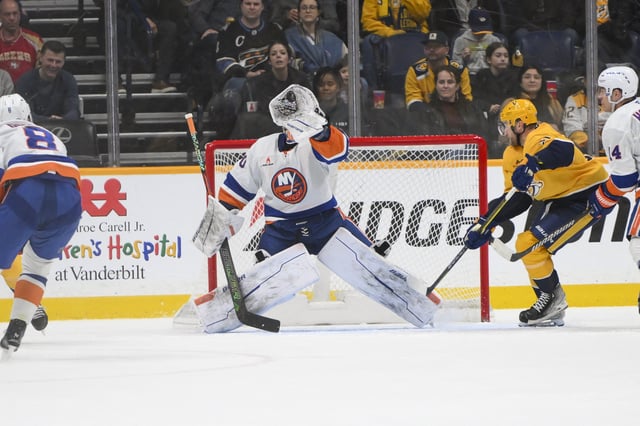 Apr 8, 2025; Nashville, Tennessee, USA;  New York Islanders goaltender Ilya Sorokin (30) makes a glove save against the Nashville Predators during the second period at Bridgestone Arena. Mandatory Credit: Steve Roberts-Imagn Images