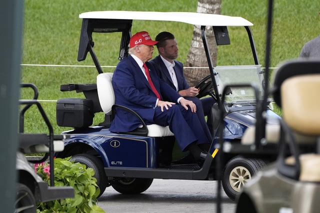 President Donald Trump, driven by his son Eric Trump, arrives at Trump National Doral during the LIV Golf Miami tournament, Thursday, April 3, 2025, in Miami.